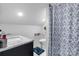 Cozy bathroom featuring a marble vanity top, modern fixtures, and a stylish blue patterned shower curtain at 704 N Main Ave, Newton, NC 28658