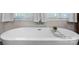 This bathroom showcases a modern, freestanding bathtub with stylish fixtures and a tiled backdrop at 704 N Main Ave, Newton, NC 28658