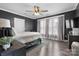 Bedroom showcasing dark gray walls, hardwood floors, large windows, and a comfortable queen bed at 704 N Main Ave, Newton, NC 28658