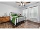 Light and airy bedroom featuring a black metal bed frame, wood floors, and natural light at 704 N Main Ave, Newton, NC 28658