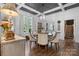 Elegant dining room with coffered ceiling, modern chandelier, and natural light at 704 N Main Ave, Newton, NC 28658
