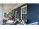 Relaxing front porch with wicker chairs, blue and white cushions, and patriotic decorations at 704 N Main Ave, Newton, NC 28658