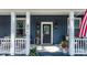 Inviting front porch with decorative touches, black door, and patriotic decor at 704 N Main Ave, Newton, NC 28658