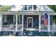 Charming front porch decorated with patriotic decor, offering a welcoming entrance to the home at 704 N Main Ave, Newton, NC 28658