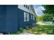 View of the home's blue brick exterior, highlighting the landscaping and windows at 704 N Main Ave, Newton, NC 28658