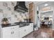Modern kitchen with updated tile backsplash, stainless steel range and hood with views into the dining room at 704 N Main Ave, Newton, NC 28658