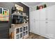 Laundry room featuring white cabinets, updated appliances, modern decor, and black accent wall at 704 N Main Ave, Newton, NC 28658