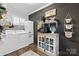 Laundry room featuring updated appliances, modern decor, and decorative wood accent wall at 704 N Main Ave, Newton, NC 28658