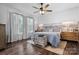 Primary bedroom featuring a decorative accent wall, ceiling fan, and two large windows at 704 N Main Ave, Newton, NC 28658