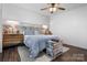 Primary bedroom featuring a decorative headboard, ceiling fan, and natural light at 704 N Main Ave, Newton, NC 28658