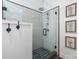 Beautifully tiled shower features glass enclosure, rainfall shower head, and updated fixtures at 704 N Main Ave, Newton, NC 28658
