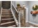 Charming staircase with dark wood treads, white risers, and decorative iron railings at 704 N Main Ave, Newton, NC 28658
