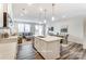 Contemporary kitchen featuring a central island with bar seating and views of the adjacent living spaces at 7126 Hodges Meadow Ln, Charlotte, NC 28213