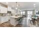 Modern kitchen featuring white cabinetry, stainless steel appliances, and an island with seating at 7126 Hodges Meadow Ln, Charlotte, NC 28213