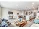 Spacious living room with modern furniture, a flat-screen TV, and open access to the kitchen and dining areas at 7126 Hodges Meadow Ln, Charlotte, NC 28213