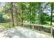 Wood deck surrounded by mature trees and natural scenery at 7154 Woodcock Trl, Stanley, NC 28164