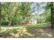Two story house with a large backyard and wooded lot features a red basement and white siding at 7154 Woodcock Trl, Stanley, NC 28164