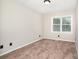 Bright bedroom featuring neutral walls, plush carpeting, and a sunlit window at 7154 Woodcock Trl, Stanley, NC 28164