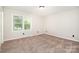 Neutral bedroom with natural light and carpet at 7154 Woodcock Trl, Stanley, NC 28164