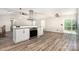 Bright kitchen with stainless steel appliances and laminate flooring at 7154 Woodcock Trl, Stanley, NC 28164