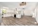 Spacious kitchen opens to the living room with luxury vinyl plank flooring and a fireplace at 7154 Woodcock Trl, Stanley, NC 28164