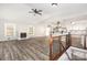 Open concept living area with modern luxury vinyl plank, fireplace and stair access at 7154 Woodcock Trl, Stanley, NC 28164