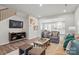 Inviting living room featuring wood floors, neutral tones, and a staircase nearby at 7217 Hodges Meadow Ln, Charlotte, NC 28213