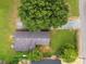 Overhead shot reveals the roof, grassy yard, mature trees, and neighbor's roof at 80 Sumner Nw Ave, Concord, NC 28027