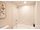 Clean bathroom with neutral tile surround, silver shower head and fixtures, and framed wall art at 80 Sumner Nw Ave, Concord, NC 28027