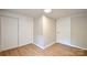 This is a bedroom with light hardwood floors, white walls, and a closet with sliding doors at 80 Sumner Nw Ave, Concord, NC 28027