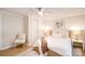 A well-lit bedroom features a ceiling fan, a chair, and a closet with sliding doors at 80 Sumner Nw Ave, Concord, NC 28027