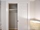 This is a closet with an open sliding door next to a table lamp. The closet has shelves at 80 Sumner Nw Ave, Concord, NC 28027