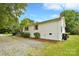 Charming white brick home with wood shutters, lush landscaping, and a gravel driveway at 80 Sumner Nw Ave, Concord, NC 28027