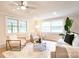 Bright living room with ceiling fan, modern furniture, and large windows for natural light at 80 Sumner Nw Ave, Concord, NC 28027