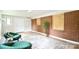Living room with brick accent wall, wood flooring, and comfortable seating area at 80 Sumner Nw Ave, Concord, NC 28027