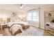 A nicely staged main bedroom features a large rug, a ceiling fan, and light from the large windows at 80 Sumner Nw Ave, Concord, NC 28027