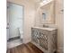 Elegant bathroom featuring a decorative vanity with marble countertop and a stylish mirror at 8337 Norcroft Dr, Charlotte, NC 28269