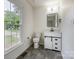 Well-lit bathroom featuring modern fixtures, decorative vanity, and stylish tile flooring at 8337 Norcroft Dr, Charlotte, NC 28269