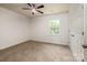 Bright bedroom featuring neutral carpet, fresh paint and a ceiling fan for added comfort at 8337 Norcroft Dr, Charlotte, NC 28269