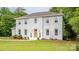 Charming two-story home with a white brick exterior and well-manicured front lawn at 8337 Norcroft Dr, Charlotte, NC 28269