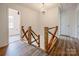 Bright hallway features custom wood banister and lots of natural light at 8337 Norcroft Dr, Charlotte, NC 28269