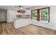 Contemporary kitchen boasts custom wood countertops, white cabinetry, natural light, and sleek finishes at 8337 Norcroft Dr, Charlotte, NC 28269