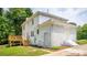 Rear exterior view of a beautiful two-story white brick home with a wooden deck and backyard at 8337 Norcroft Dr, Charlotte, NC 28269