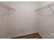 Spacious walk-in closet with wire shelving and laminate floor at 8337 Norcroft Dr, Charlotte, NC 28269