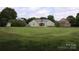 The expansive backyard features a well-manicured lawn, lush landscaping, and room for outdoor activities and entertaining at 8829 Gelligum Dr, Charlotte, NC 28277