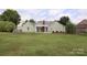 The lush backyard features a pergola-covered patio and mature trees, offering a serene space for outdoor living and relaxation at 8829 Gelligum Dr, Charlotte, NC 28277