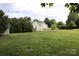 The expansive backyard features a well-manicured lawn, lush landscaping, and room for outdoor activities and entertainment at 8829 Gelligum Dr, Charlotte, NC 28277