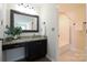 The bathroom features granite counters, a decorative mirror, and a bright step-in shower for added elegance and convenience at 8829 Gelligum Dr, Charlotte, NC 28277