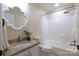Bathroom with granite vanity, decorative mirror, and a shower-tub combination at 8829 Gelligum Dr, Charlotte, NC 28277