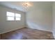 Bright bedroom with hardwood floors, a ceiling fan, and ample natural light at 8829 Gelligum Dr, Charlotte, NC 28277